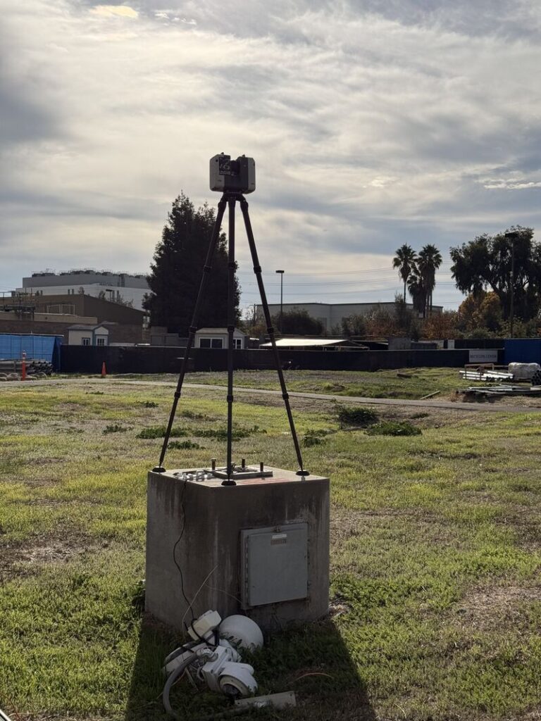 Leica RTC360 laser scanner positioned on an old abandoned square concrete light-post base during a GTEC3D outdoor scanning project.