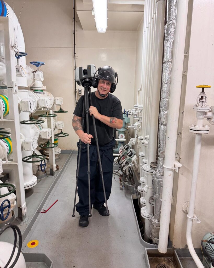 Alex Murrell of GTEC3D uses a Leica RTC360 laser scanner on a tripod to capture the precise geometry of a ship's engine room for a scrubber (EGCS) addition.