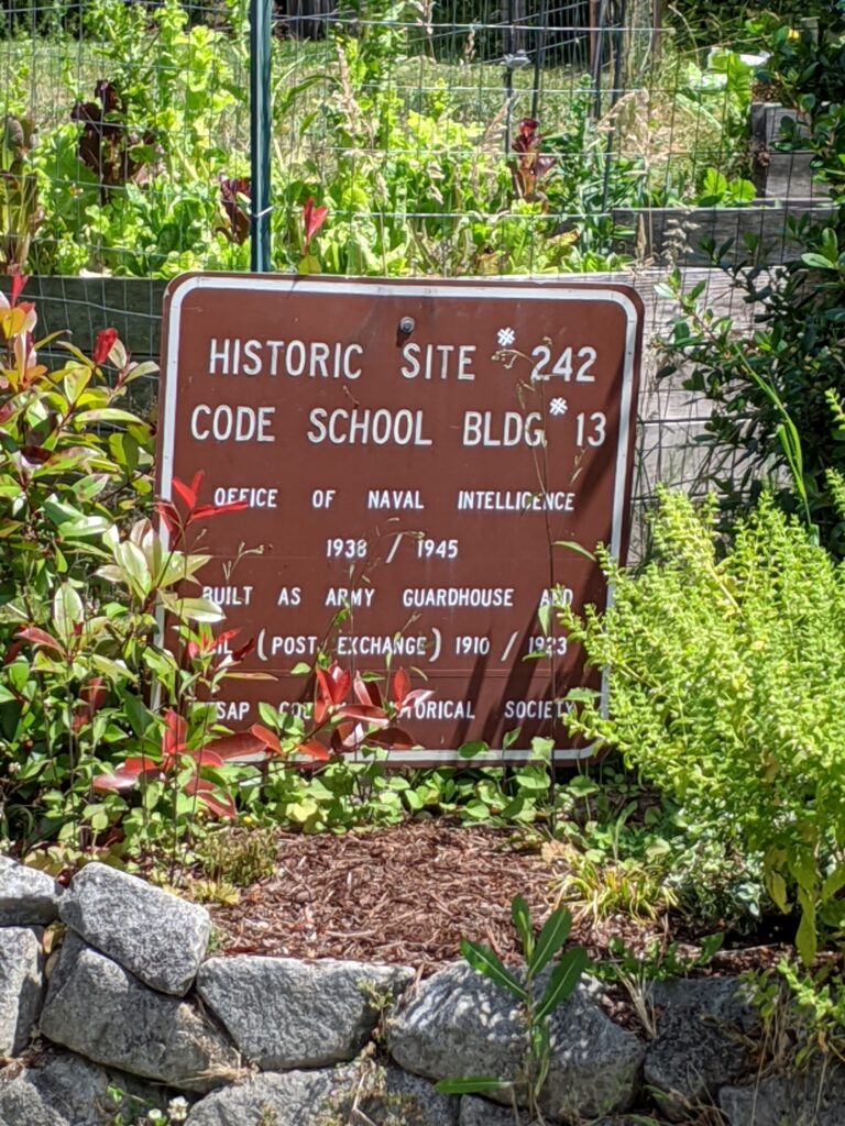 A clear photograph taken with a Nikon ZF camera shows Eric Guizzetti standing next to a weathered historic site informational sign, set against an outdoor, natural background.