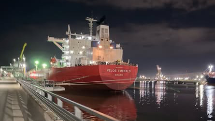 A detailed 3D point cloud visualization of a ship's engine room, showing a dense network of pipes, machinery, and structural beams in vibrant digital colors. The scan captures the complex internal geometry of the Velos Emerald for engineering design.