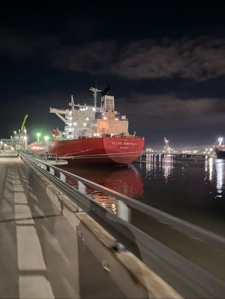 A detailed 3D point cloud visualization of a ship's engine room, showing a dense network of pipes, machinery, and structural beams in vibrant digital colors. The scan captures the complex internal geometry of the Velos Emerald for engineering design.