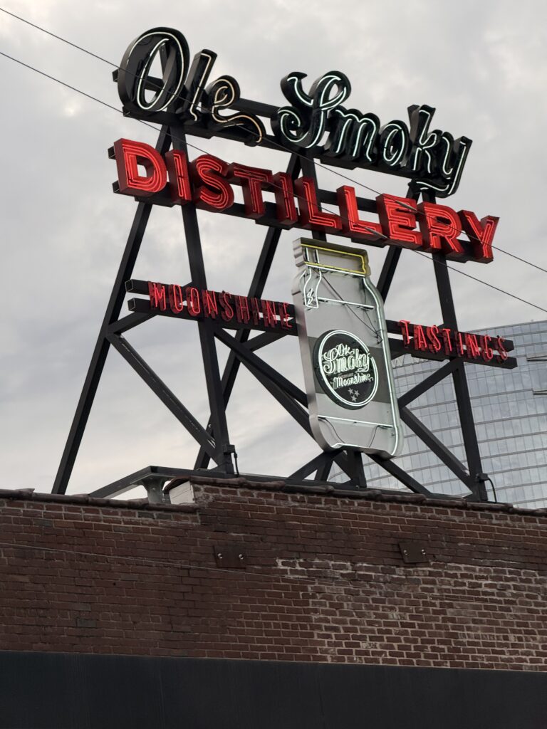 Ole Smoky Moonshine tasting sign mounted on the exterior of Old Smoky Distillery, photographed in daylight by Eric Guizzetti of GTEC3D.